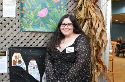 Someone posing in front of their art