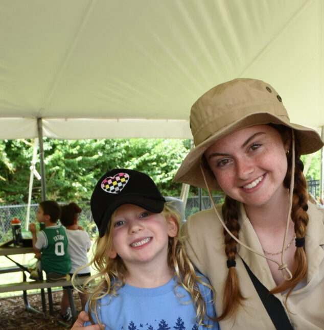 Camp counselor posing with camper