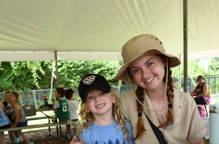 Camp counselor posing with camper