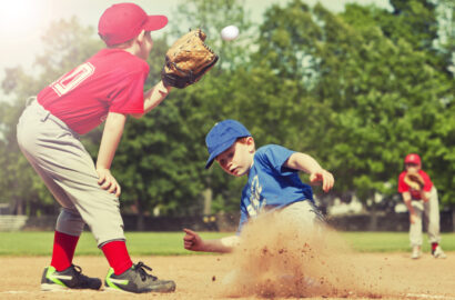 Boy sliding into base during a baseball game with Instagram style filter.
