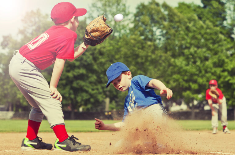 Boy sliding into base during a baseball game with Instagram style filter.