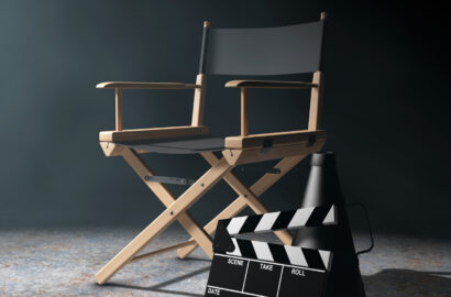 Director Chair, Movie Clapper and Megaphone in the volumetric light on a black background. 3d Rendering.