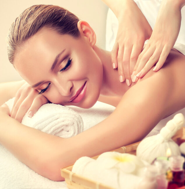 Massage and body care. Spa body massage treatment. Woman having massage in the spa salon for beautiful girl.