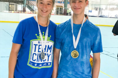 Two teens wearing medals.
