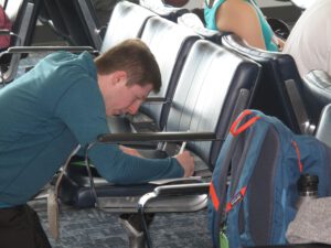 Man writing while waiting at the airport