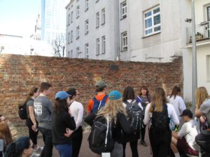 People stand next to wall in Warsaw