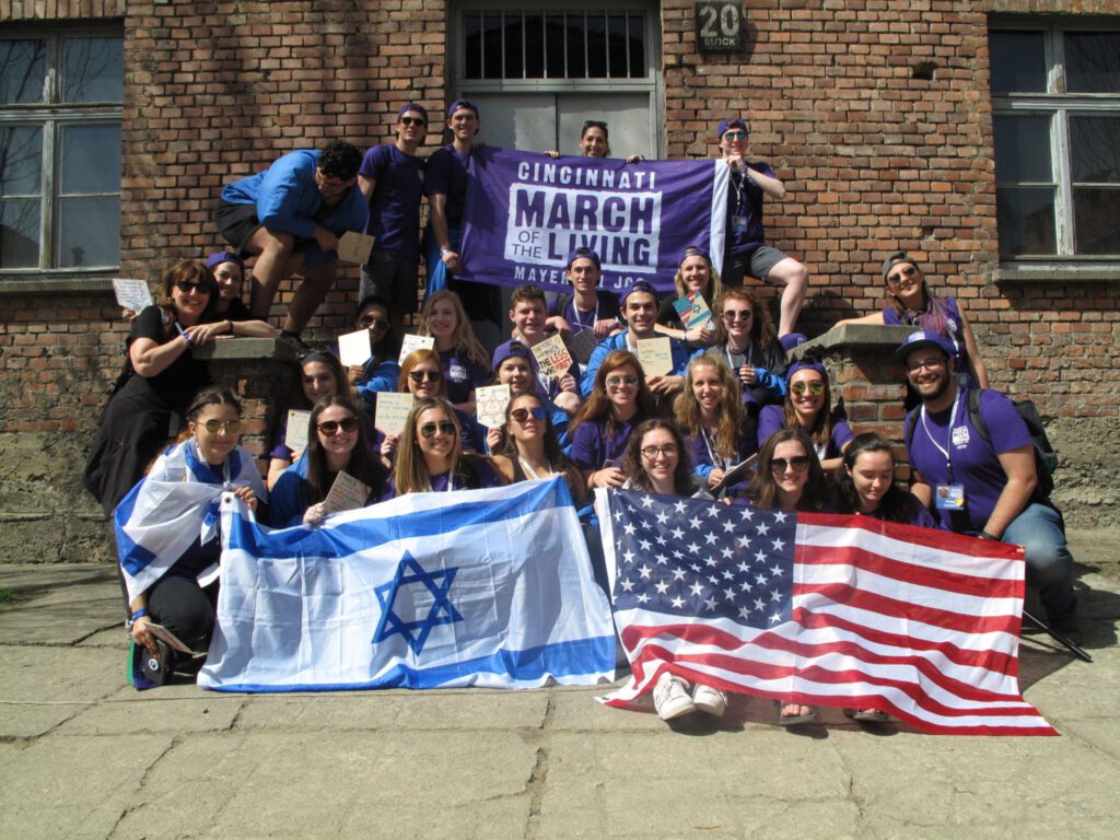 Group photo with flags of March of the Living, Israel, and United States