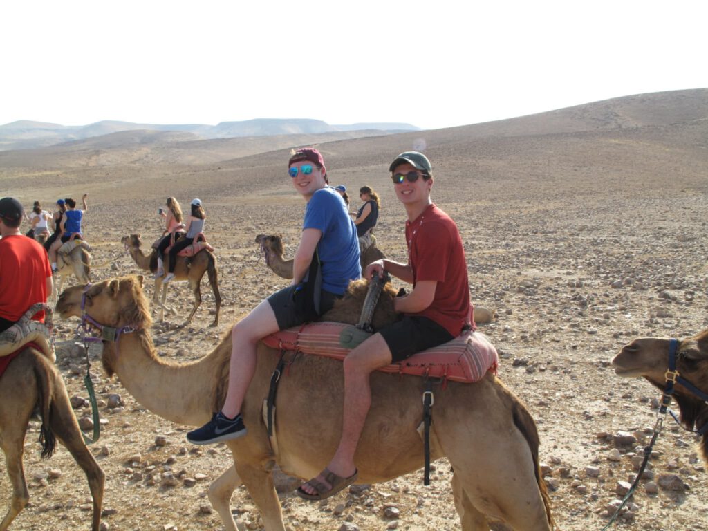 People ride on a camel
