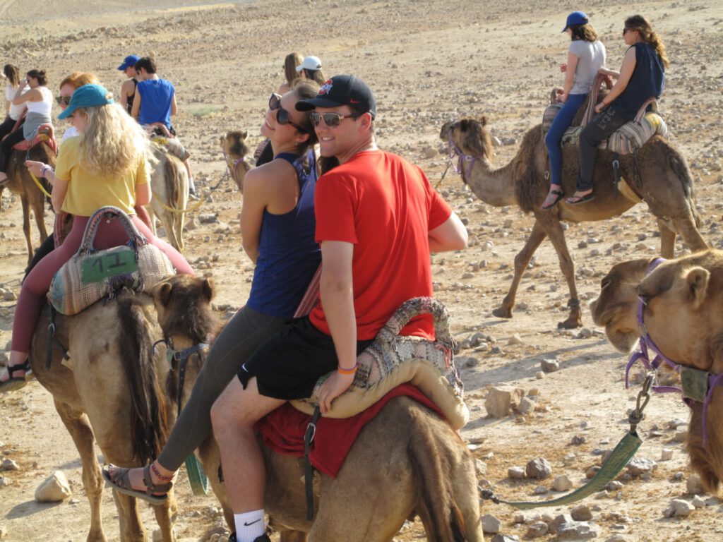 People ride on a camel
