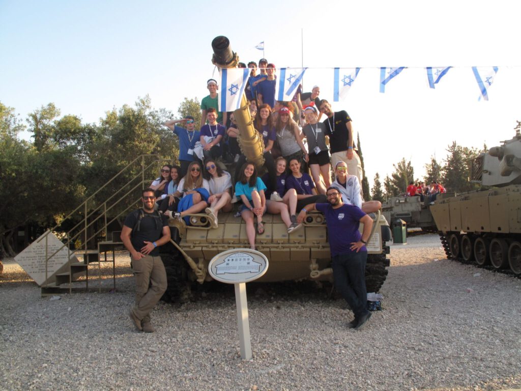 People pose for a group picture on tank