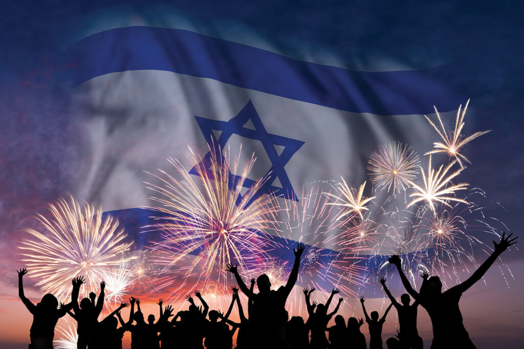 Happy people are looking holiday fireworks with flag of Israel in sky, independence day.