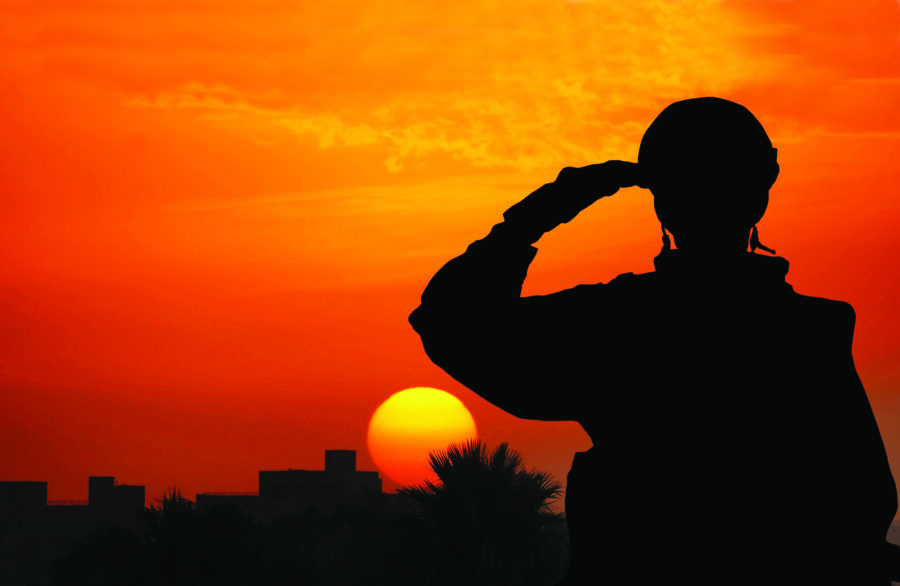 Silhouette Of A Solider Saluting Against the Sunrise in a town on the Mediterranean coast.