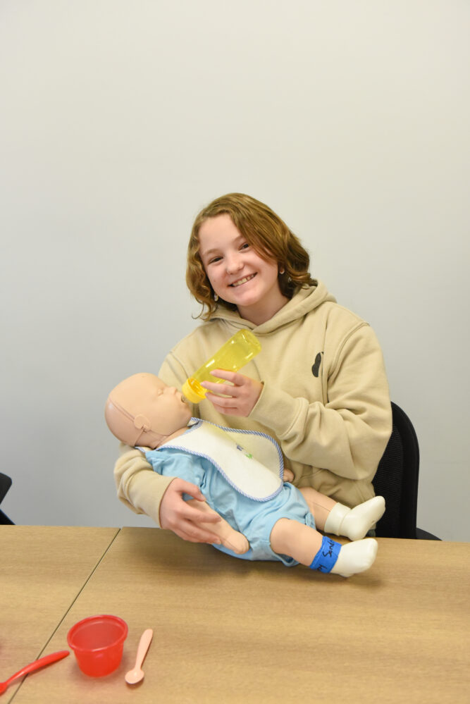 Teen at babysitting class