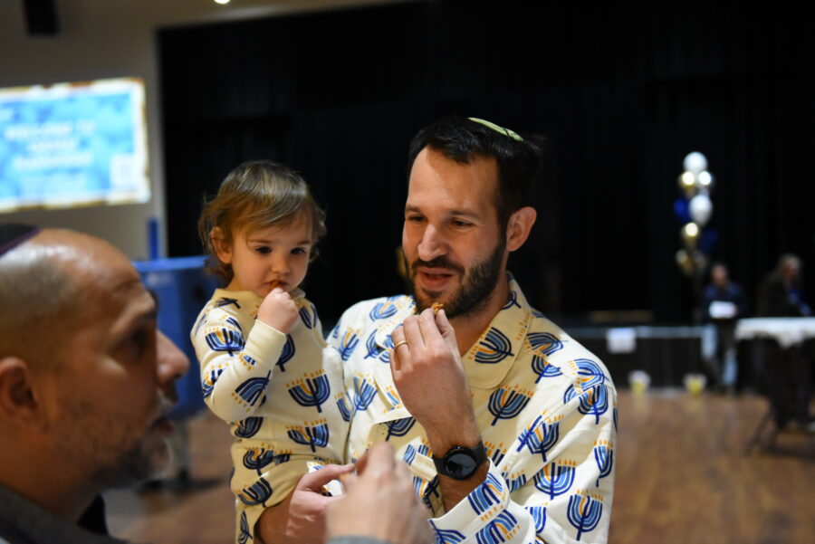 Parent and child in Hanukkah pajamas