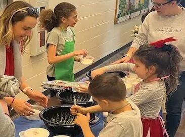 Kids helping make food.