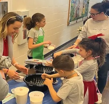Kids helping make food.