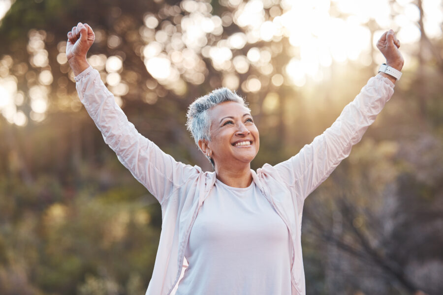Senior woman, smile and nature while outdoor for freedom, happiness and a healthy lifestyle with fitness and fresh air. Face of happy black female at park for peace, health and wellness in summer.