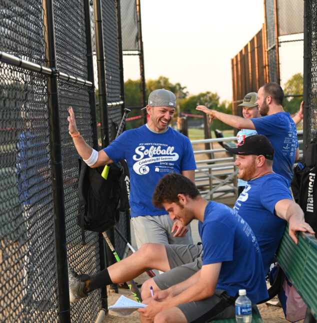 men at the Softball Fastpitch talking