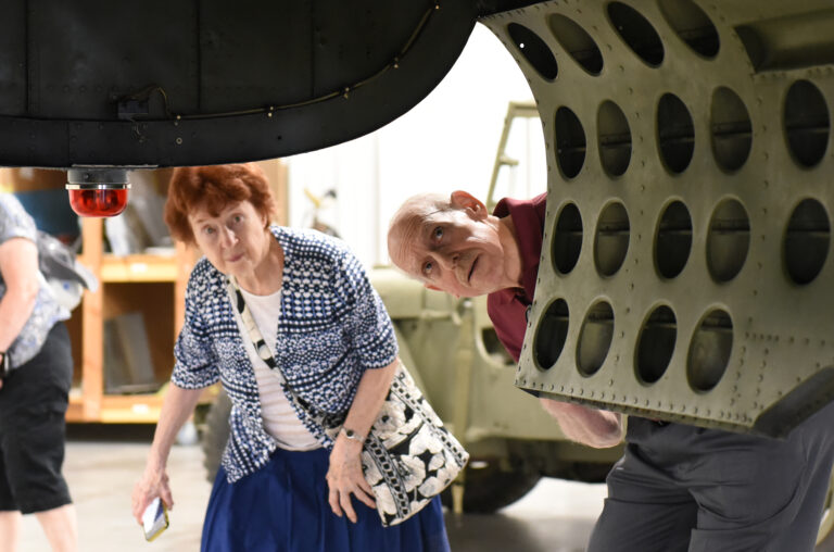 Someone looking at airplane at the Warbird museum