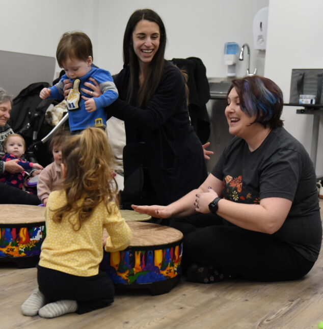 Kids playing during Tots and Tunes with adults
