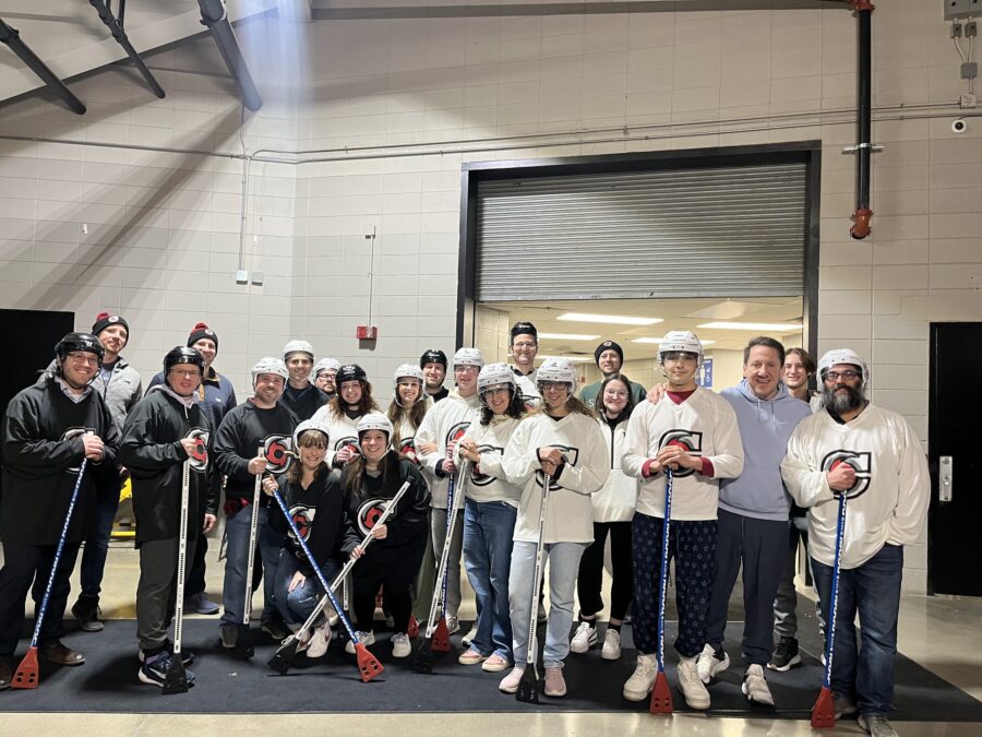 People standing in Cyclones hockey gear posing for a picture