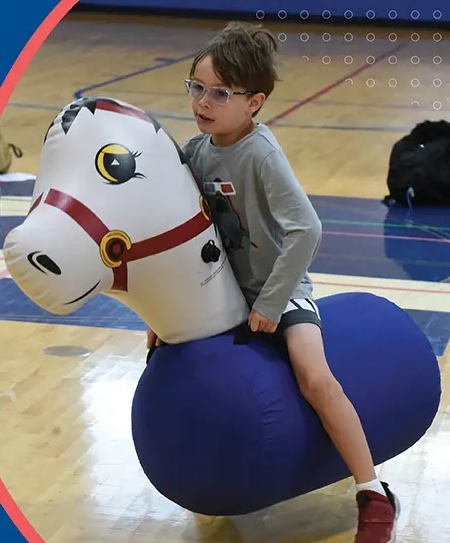 Kid on an inflatable horse