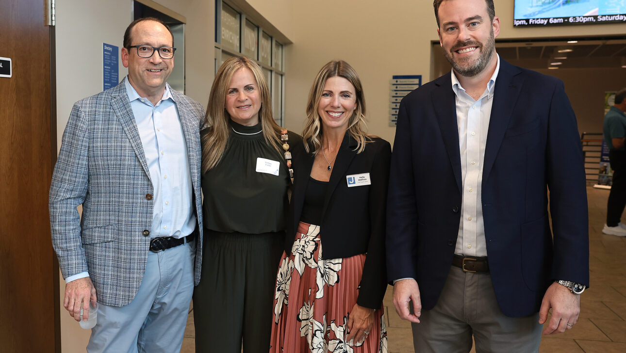 Marc Fisher standing with his wife, Evelyn and colleagues Holly Wolfson and Bob Oestreicher