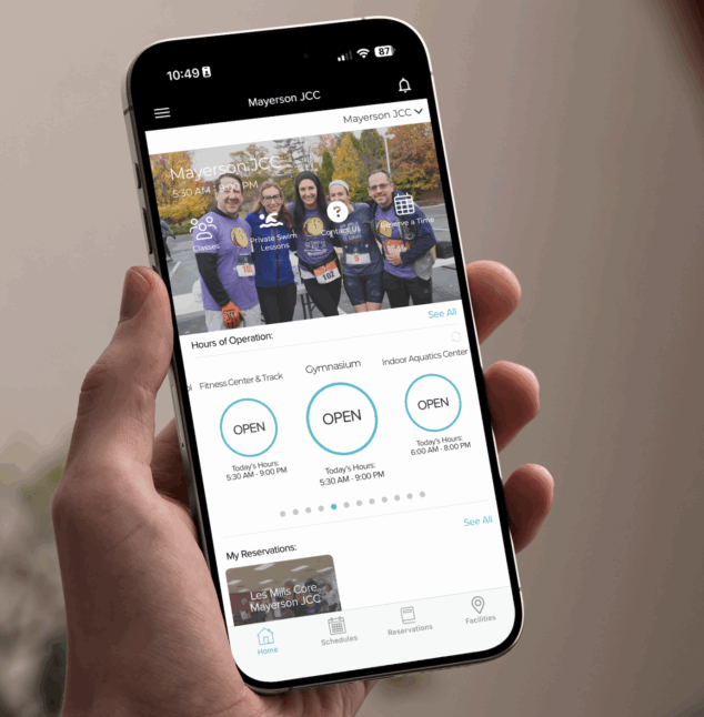 Someone holding a cell phone with the My J App on it.