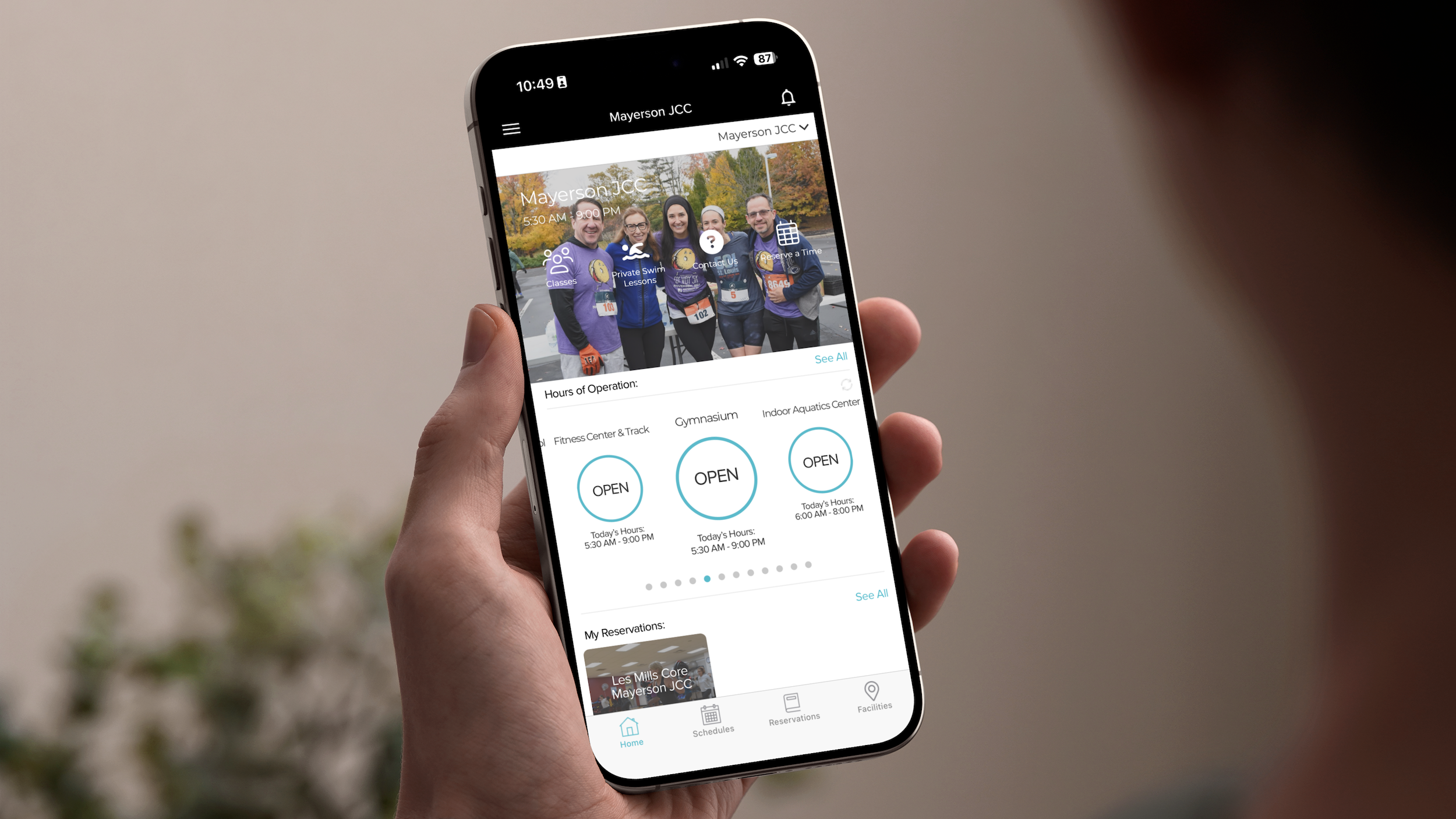 Someone holding a cell phone with the My J App on it.