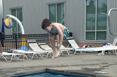 Kid jumping into a pool.