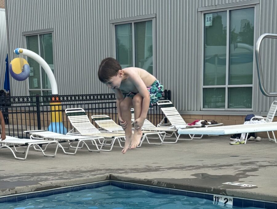 Kid jumping into a pool.