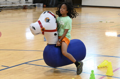Kid on inflatable horse