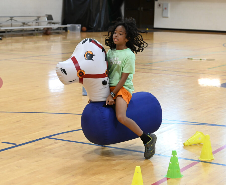 Kid on inflatable horse