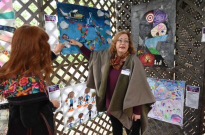 Person looking at art work under the sukkah.