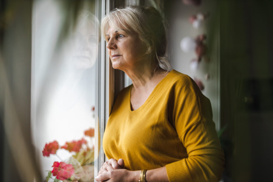 Senior woman staring out of window
