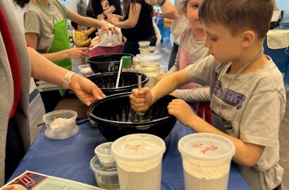 Child mixing dough in a bowl