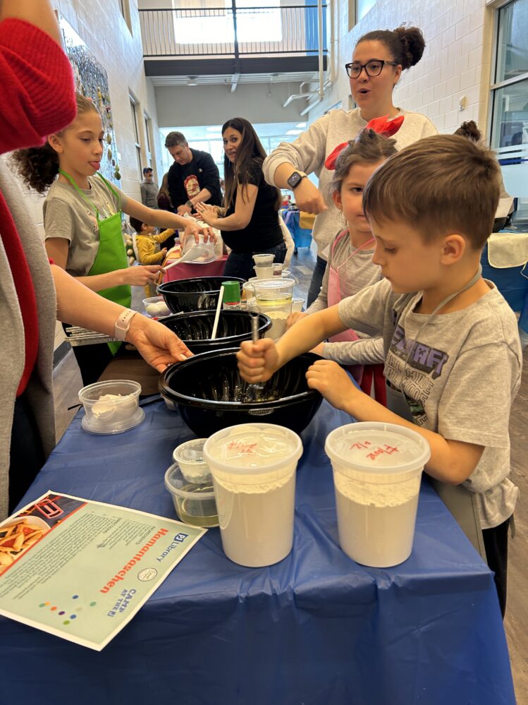 Child mixing dough in a bowl