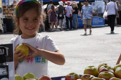 Kid at an apple booth