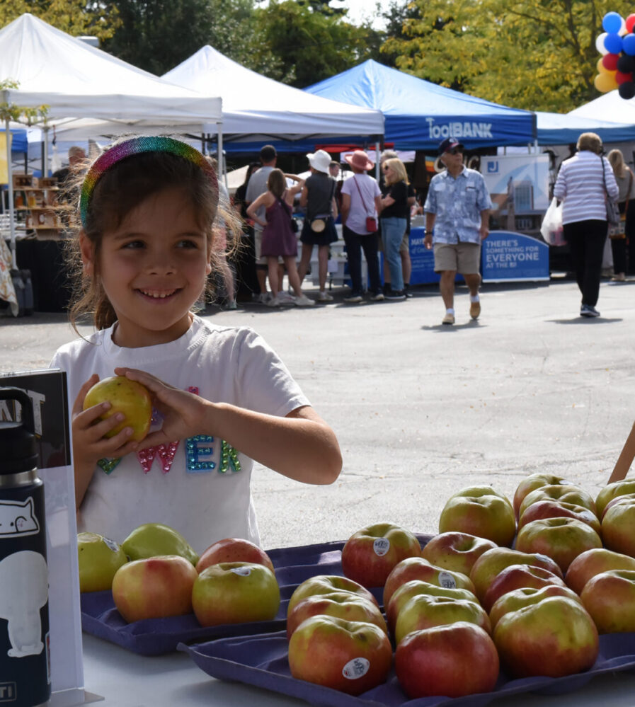 Kid at an apple booth