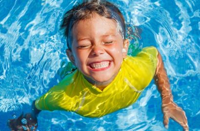 Kid swimming in a pool.