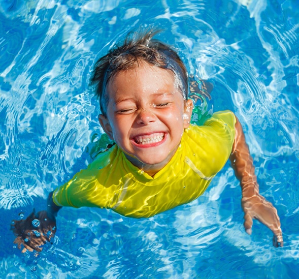 Kid swimming in a pool.